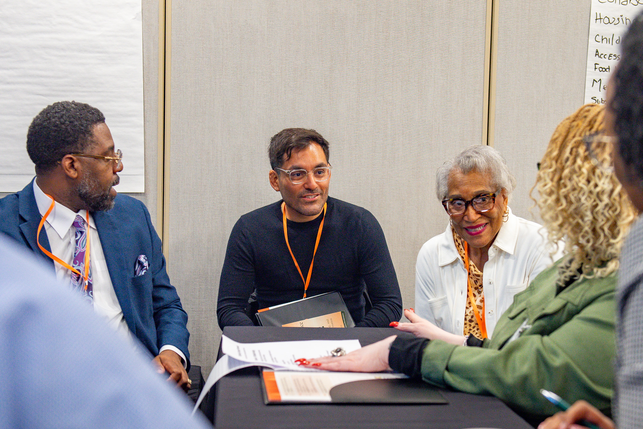 Community leaders collaborating around a table at a convening